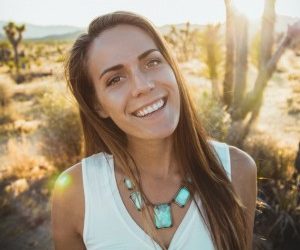 Woman tilting her head and smiling with white teeth