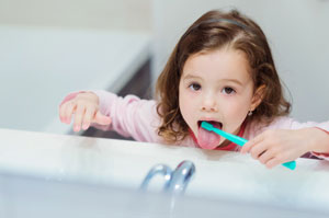 Little girl brushing her teeth