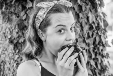 Woman biting into an apple (black and white)