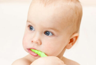 Baby brushing his own teeth
