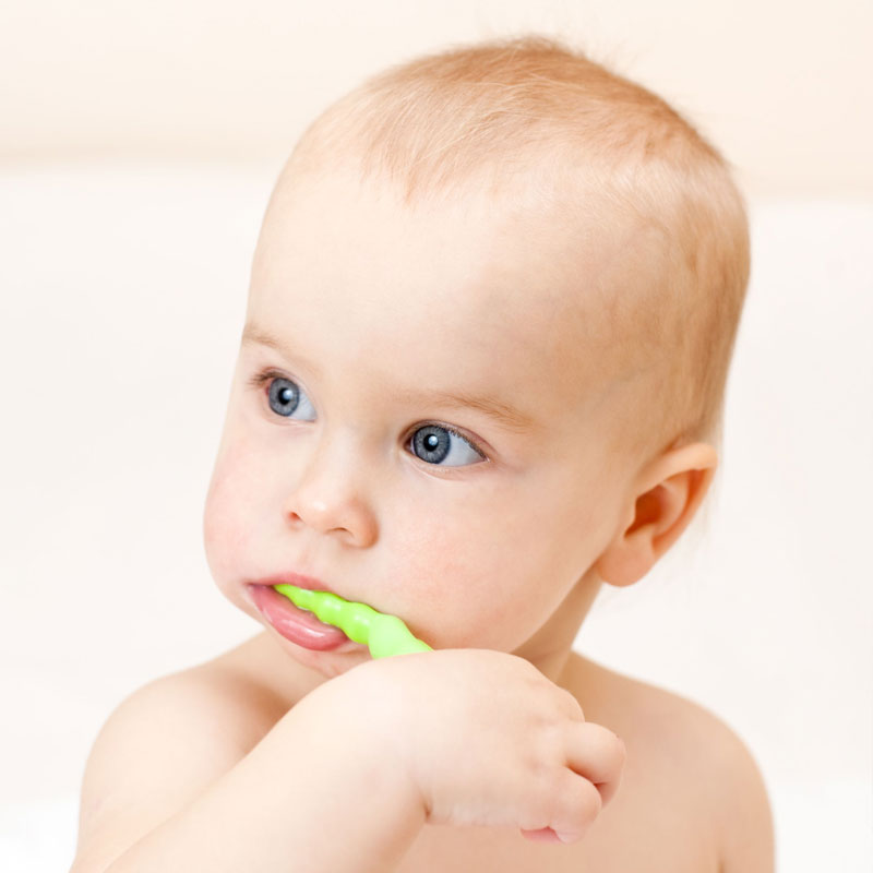 Baby brushing his own teeth